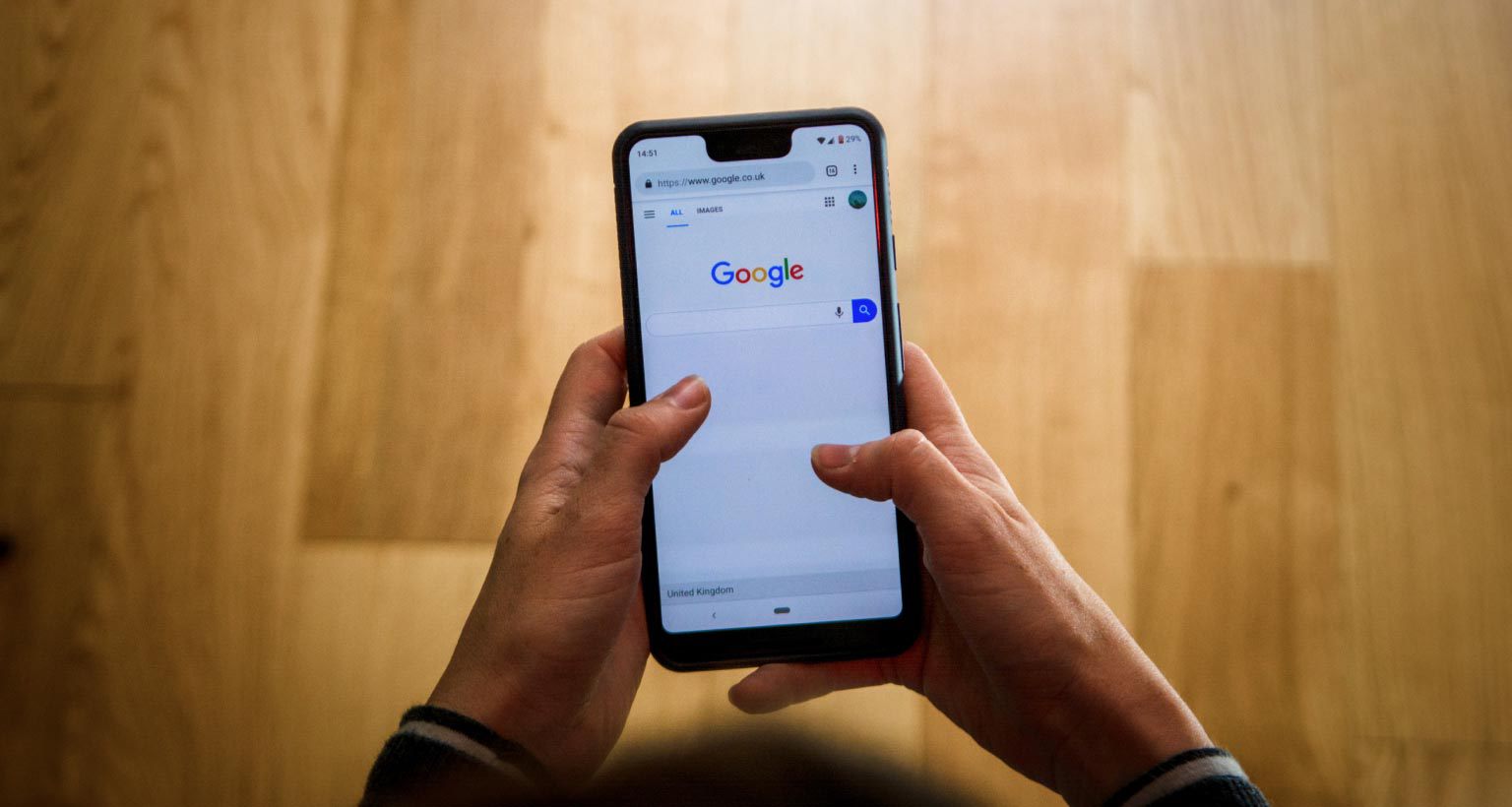 person looking at google on a smart phone